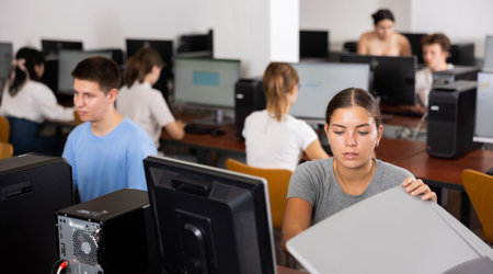 Female teacher uses a scanner in computer lab at school