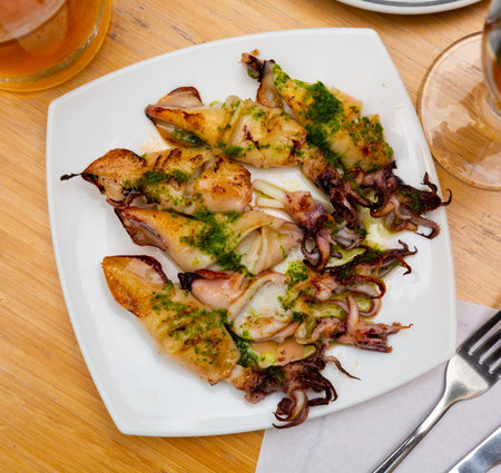 Barbecue squid drizzled with spinach sauce.