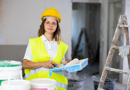Portrait of smiling woman painter in apartment
