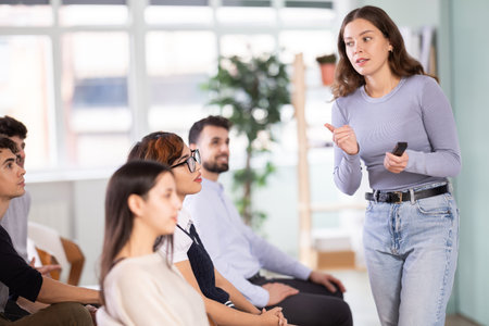 Female teacher explaining topic to students using digital board