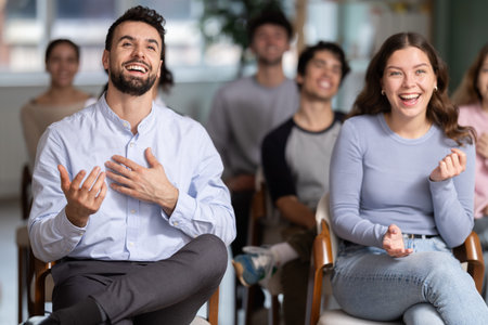 Group of happy students laughing during educational class
