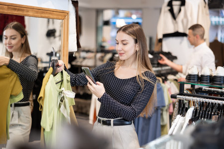 Young woman makes video call and chooses blouse