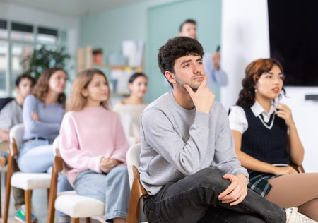 Students sit attentively in the classroom and listen to lectures