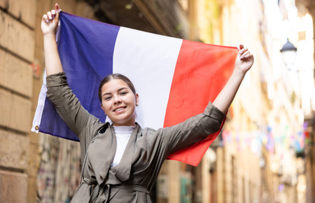Young smiling woman holding France flagの写真素材