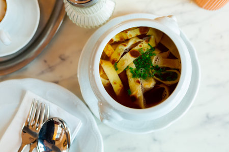 Frittatensuppe, served in bowl on tableの写真素材