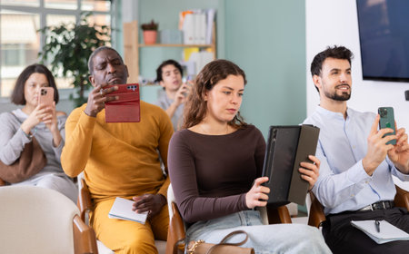 Lecture participants take photos of presentation slide or scan QR codeの写真素材