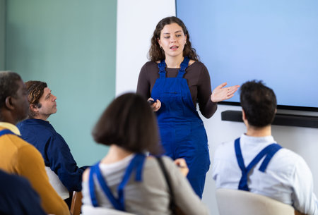 Young woman worker gives lecture in auditoriumの写真素材