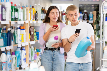 Couple man and woman scanning qr code for detergentの写真素材