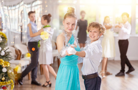 Boy and girl dancing waltz in studioの写真素材