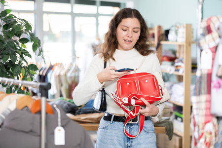 Girl interesting goods, scans QR code and label of handbag