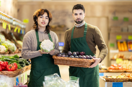Man and woman seller offer vegetables and fruitsの写真素材