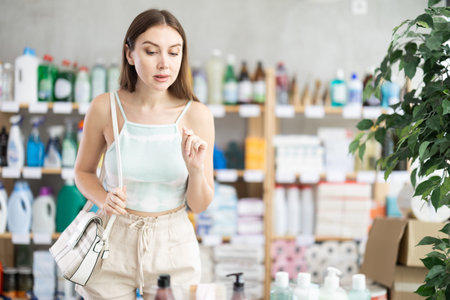 Woman looking with interest at the shelves in the supermarketの写真素材