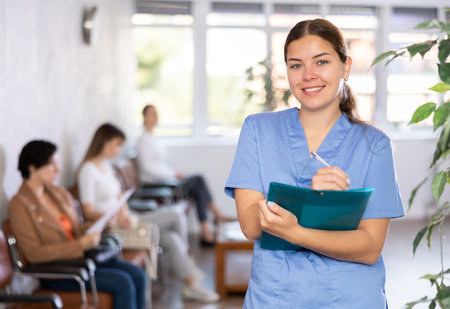 Young woman in medical uniform making notes