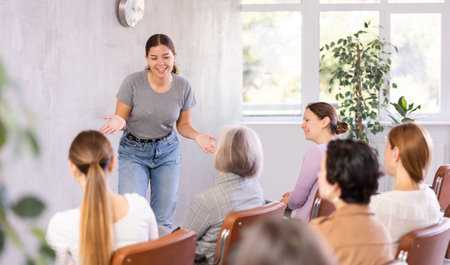 woman lecturer speaks to small audience of listeners and talks about trends, news , innovations