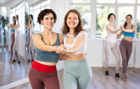 Group of women dancing pair dances in studio