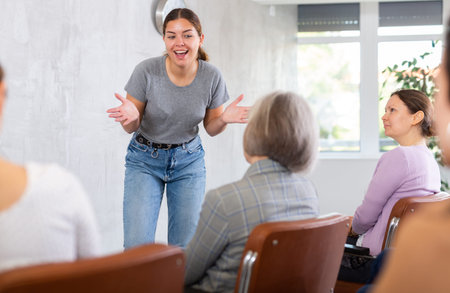 Woman tells an interesting story. Female students listening carefully in classroom