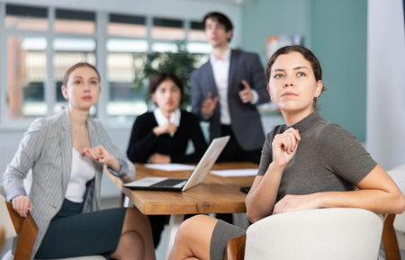 Young woman watches presentation in office