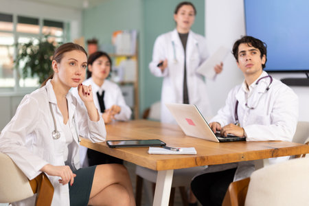 Female doctor conducts a briefing for colleagues