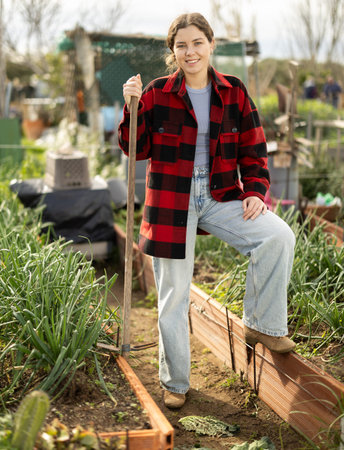 Portrait of female farmer in garden beds