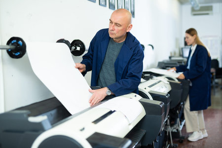 Service engineer of printing house during work