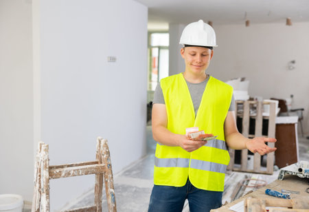 Portrait of a contented fifteen-year-old worker with the first salary