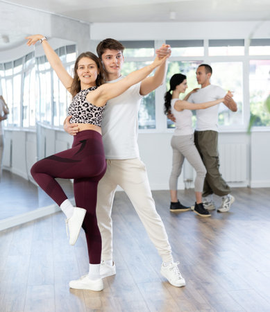 Young men and women dancing latin dances