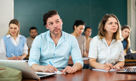Concentrated students studying in the university auditorium