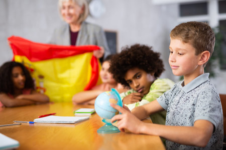students listen to woman teacher who talks about Spain