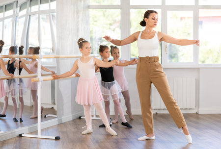 Teacher dancer performing pirouette in front of class