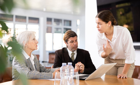 Business colleagues planning work in meeting at table in office