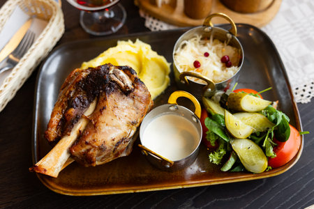 Long cooked meat served with mashed potatoes, cabbage and sauce