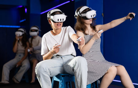 Two girls competing in team-based virtual reality game