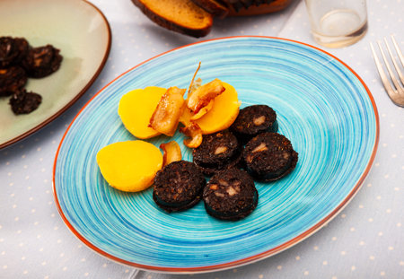 Catalan blood sausage with garnish of baked potatoes