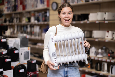 Young woman buying heater from hardware store