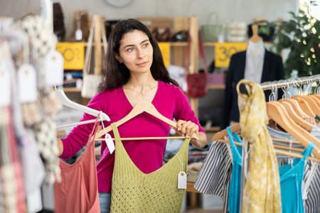 Armenian woman in a pink half-faith chooses clothes