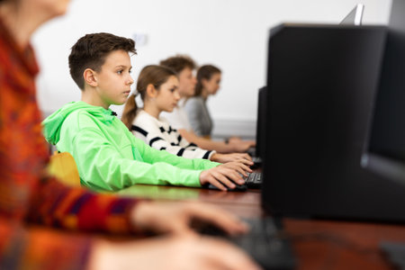 Young boy using computer during lesson