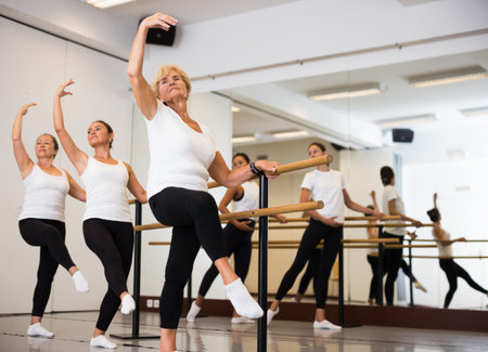 Ballet troupe of different ages in lesson in dance class