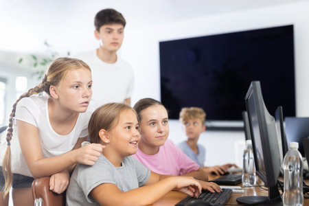 Group of students working at computer in classroom