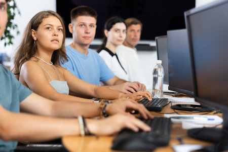 Focused girl listening to lecture during group software development course