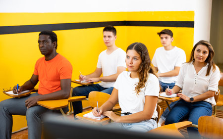 Portrait of group of people in lecture hall at extension courses