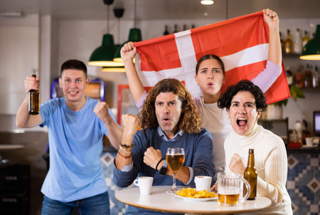 Danish fans scream with joy in beer bar. Denmark winの写真素材