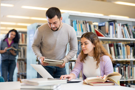 Couple of students spending time together in library