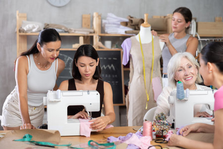 Fellow clothing designers collaborating on order in workshop