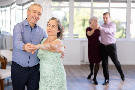 Elderly man and elderly woman dance tango