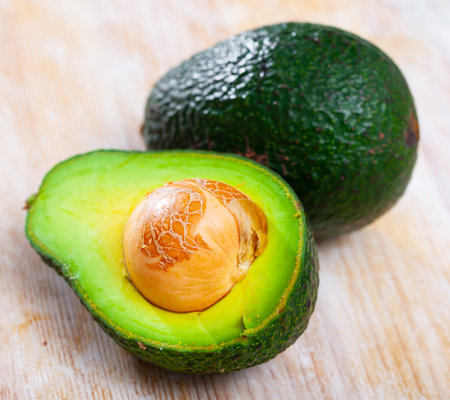Whole and halved avocados