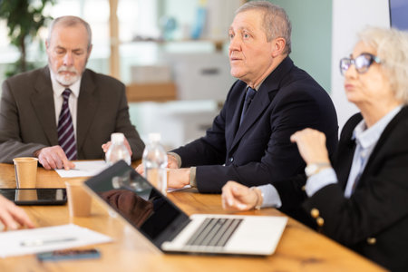 Group of eldery employees meeting in office