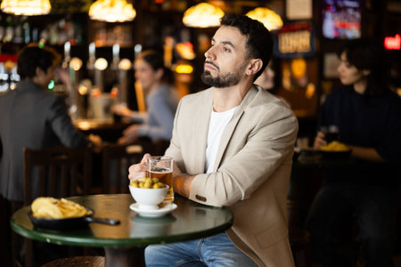 Young man spending time alone at bar