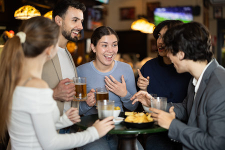Group of friends happily having time at bar