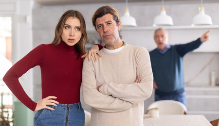 Old man quarreling with couple