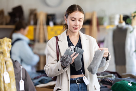 Adult woman choosing hat in clothing store